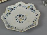 a white plate with blue and yellow flowers on it