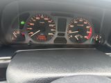 a close up of a car dashboard with a speedometer and gauges