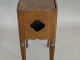 a small wooden table with a drawer on top of it