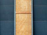 two wooden doors on the side of a building
