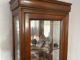 a glass display case in the corner of a room