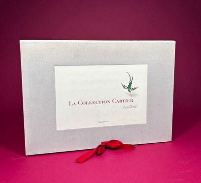 a white box with a red ribbon and a picture of a bird on it