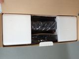 a box with a pair of black boots in it