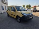 yellow and black van parked in a parking lot next to a building