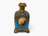 a blue and gold vase with a picture on it