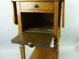 a small wooden table with a drawer on top of it