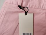 a close up of a pink pants with a tag on it