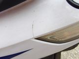 a close up of a motorcycle with a blue and white stripe on it