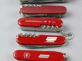 six swiss army knives are lined up in a row on a table