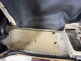 a dirty car with the door open on the floor