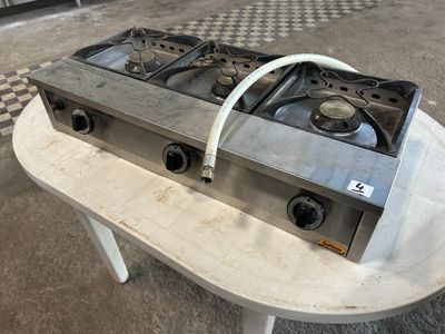 une cuisinière à gaz posée sur une table dans une cuisine