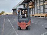 a forklift that is parked in front of a building