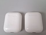 two white apple airpods sitting on top of a white table