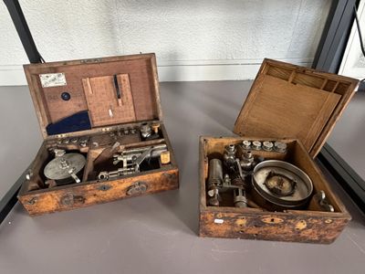 two wooden boxes that have different types of tools in them