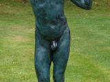 a statue of a man holding a frisbee in his hand