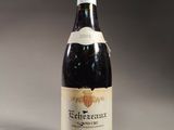 an old bottle of wine sitting on top of a table