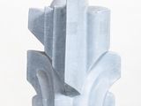 a blue sculpture on a white pedestal on a white surface