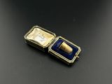 an image of a gold and blue box with a ring inside