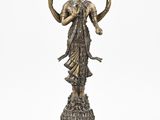a bronze statue of a woman holding a flower on a pedestal