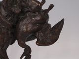 bronze statue of a dog with a bird in its mouth