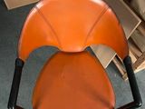 a chair that has a leather seat on it