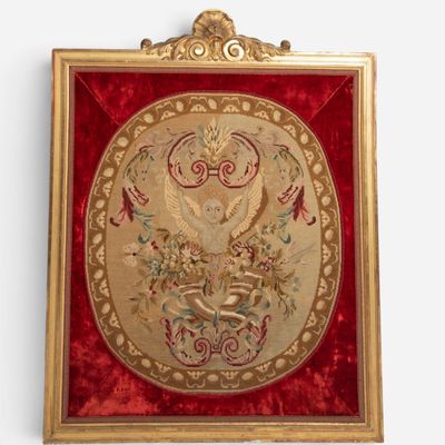an ornate gold framed picture of a bird and flowers on a red velvet background