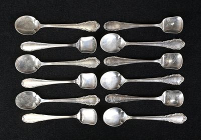 six silver spoons are arranged in a row on a black surface