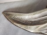 a close up of a silver shoe on a table