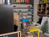 a refrigerator and a table in a room with a chalk board