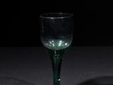 a wine glass that is sitting on a table