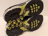 the soles of a pair of black and yellow shoes on a white surface