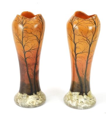 two vases with trees painted on them sitting on a white surface