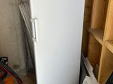 a white refrigerator that is in a room with a lot of stuff