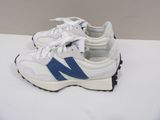 pair of white and blue new balance shoes on a white surface