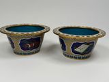pair of blue and gold vases with floral designs on them