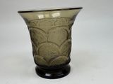 a green glass vase with a black base on a white background