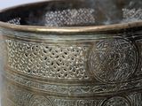 a large metal bowl with intricate designs on it