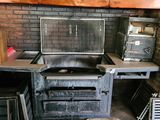 a kitchen with a stove, oven, and other appliances in it