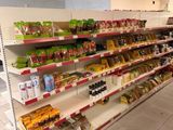 many shelves in the store that have various foods on them