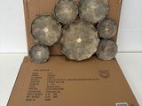 a cardboard box that has a bunch of metal flowers in it