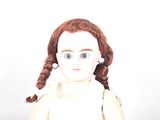 a doll that is wearing a white dress and a pair of glasses