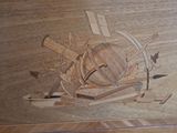 a wooden box with a picture of a wheel and tools on it