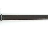 an old knife with a wooden handle on a white surface