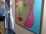 a picture of a woman with pink hair on the wall