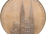 a bronze coin with a picture of a cathedral on it