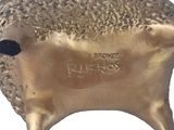 gold plated sheep figurine with black feet and a black nose