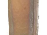 a brown vase with a yellow top sitting on a white surface