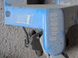 a close up of a blue machine on a concrete wall