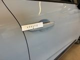 a car door handle that has a sticker on it