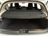 the back of a car with its trunk open and the seats folded down
